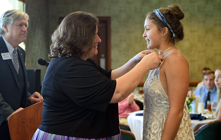 Shumadine Scholar Hope Burleson '21 of Montpelier, Virginia, is pinned by Dr. Joyce Easter, Dean of the Batten Honors College, during a special recognition ceremony held on Founders Day. 