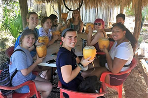 Batten Honors College students sipping fresh coconuts in the Yucatan Peninsula, Mexico.
