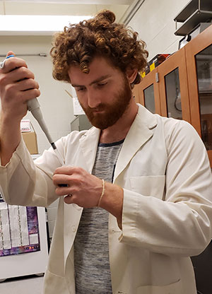 Bavuso preparing solutions in a Virginia Wesleyan biology laboratory, summer 2019. Photograph by Taylor Morich. Bavuso preparing solutions in a Virginia Wesleyan biology laboratory, summer 2019. Photograph by Taylor Morich.