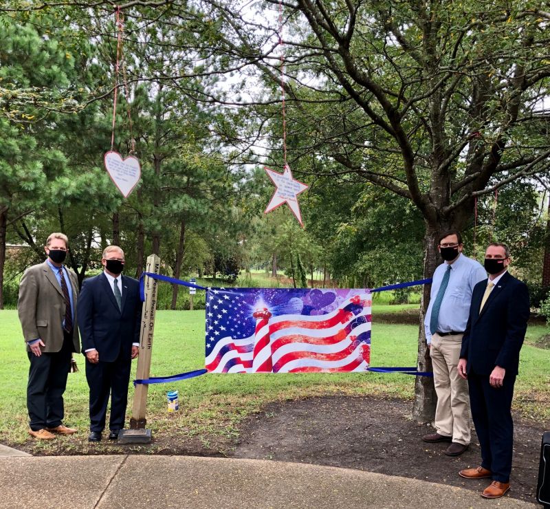 VWU UNITY FLAG: The University's newly created unity flag served as the centerpiece for the community gathering in the Peace Garden on 9/11. Pictured from left: Director of the Robert Nusbaum Center and Professor of Religious Studies Craig Wansink, President Scott D. Miller, Vice President for Academic Affairs Maynard Schaus, and Vice President for Campus Life and Operational Management Keith Moore.