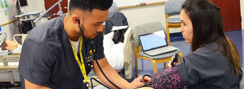 Sentara health practitioner checking patient's blood pressure