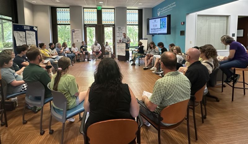 TCA students and their parents participate in a deliberative dialogue, after training by the Nusbaum Center team.