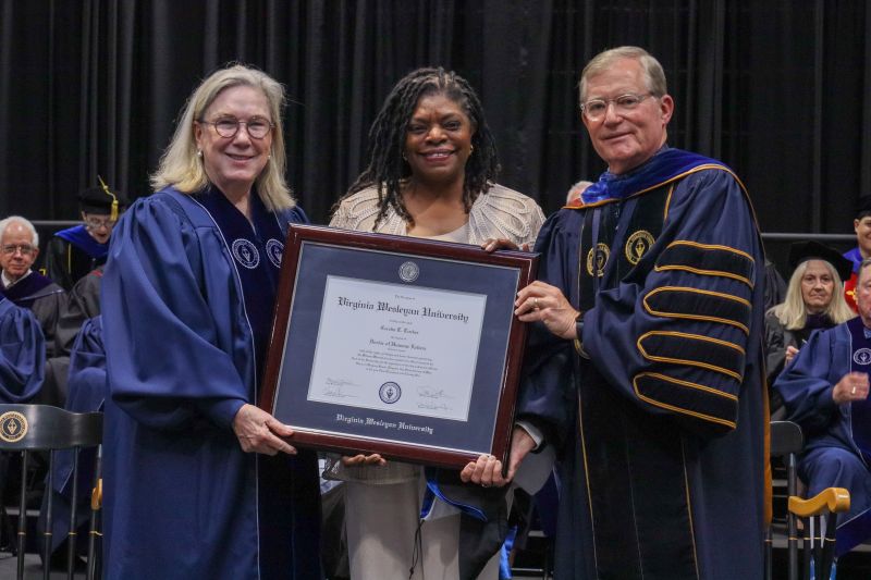 Dr. Kelly J. Tucker accepts Doctor of Humane Letters on behalf of her mother, Cecelia T. Tucker